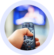 Person using TV remote to turn up volume
